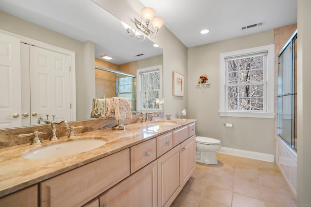 full bathroom featuring tile patterned floors, a chandelier, a healthy amount of sunlight, and toilet