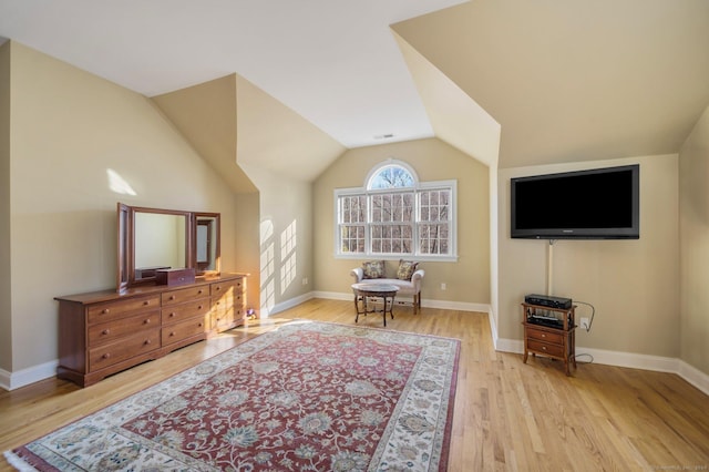 sitting room with light hardwood / wood-style flooring and lofted ceiling