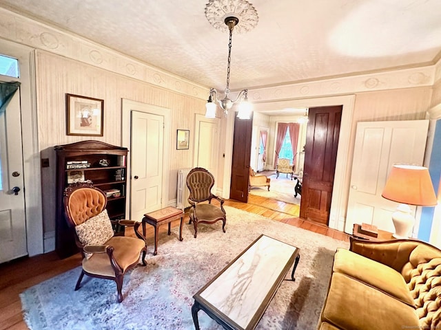 sitting room featuring light hardwood / wood-style flooring and an inviting chandelier