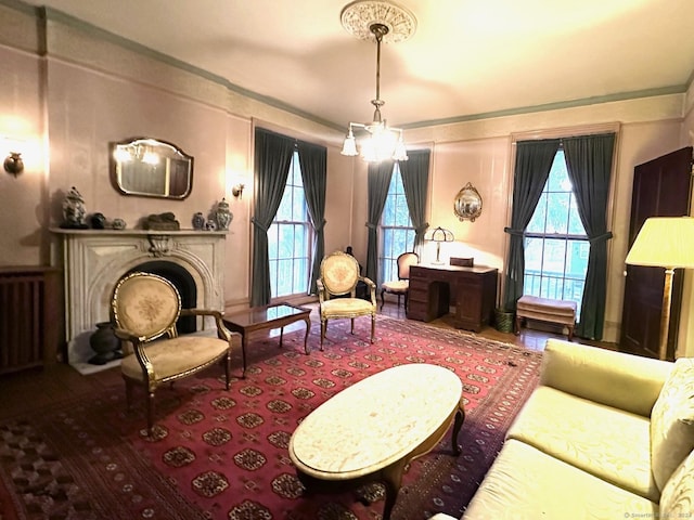 living area with radiator heating unit and an inviting chandelier