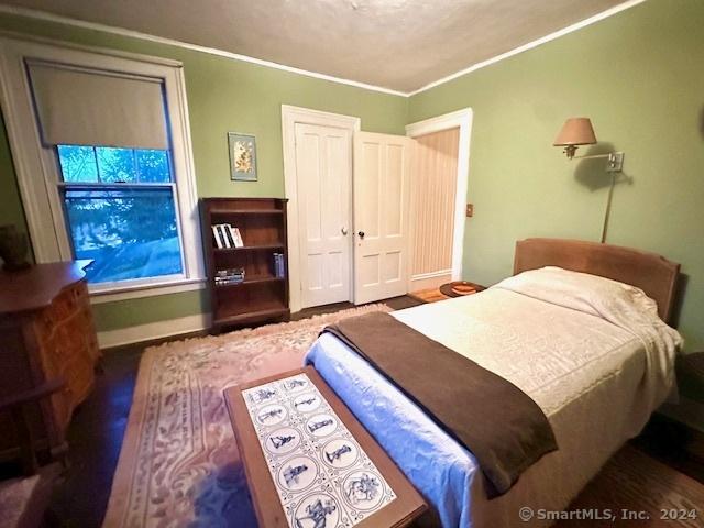 bedroom featuring ornamental molding and a closet