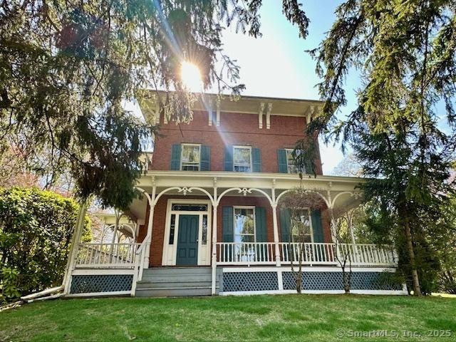 view of front of house with a porch and a front lawn
