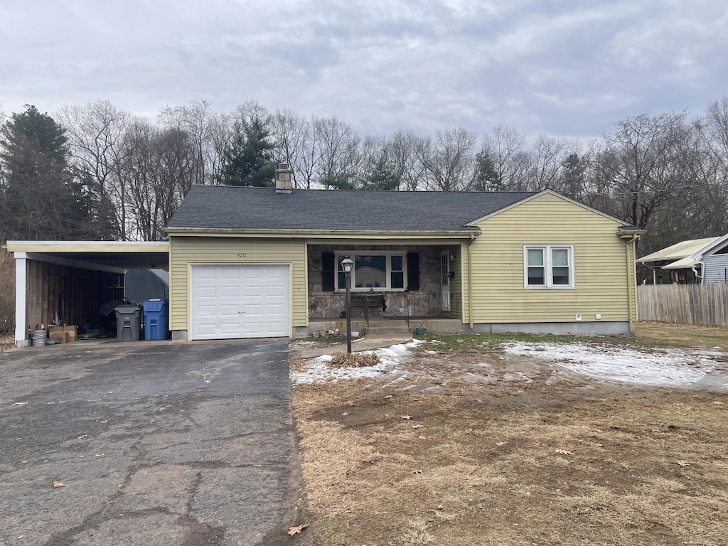 single story home featuring covered porch and a carport