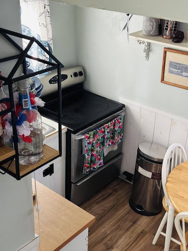 kitchen with dark hardwood / wood-style floors and range with electric stovetop