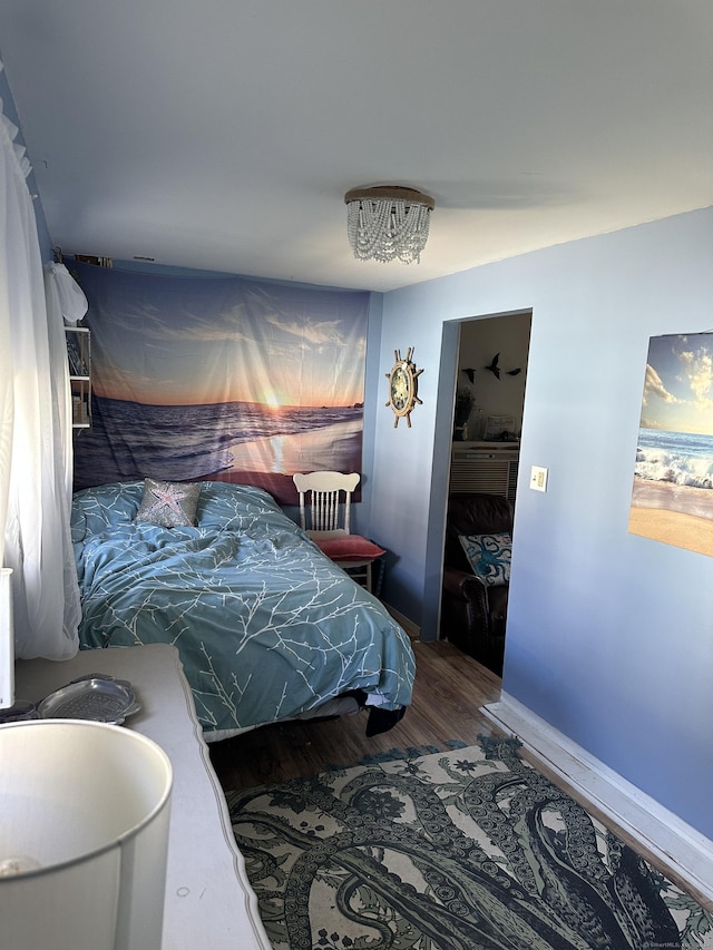 bedroom featuring hardwood / wood-style floors and a closet