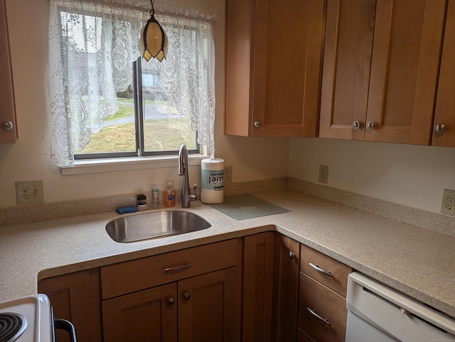 kitchen with dishwasher, sink, pendant lighting, and stove