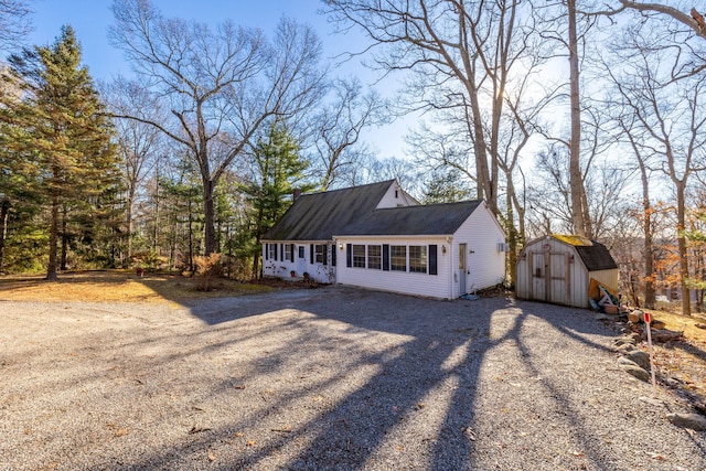 view of front of home with a shed