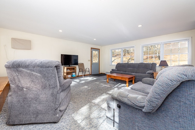 carpeted living room with baseboard heating