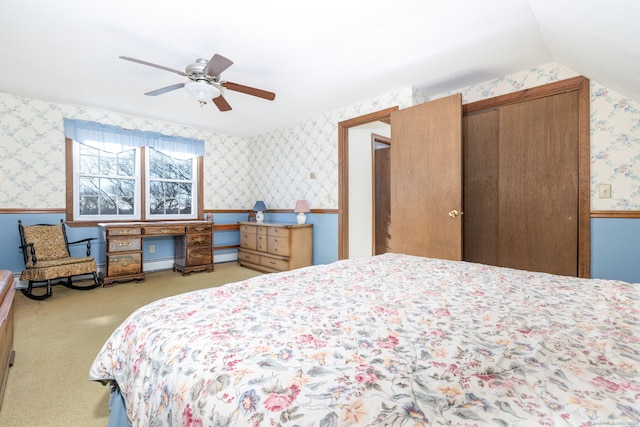 bedroom with ceiling fan, lofted ceiling, light carpet, and baseboard heating