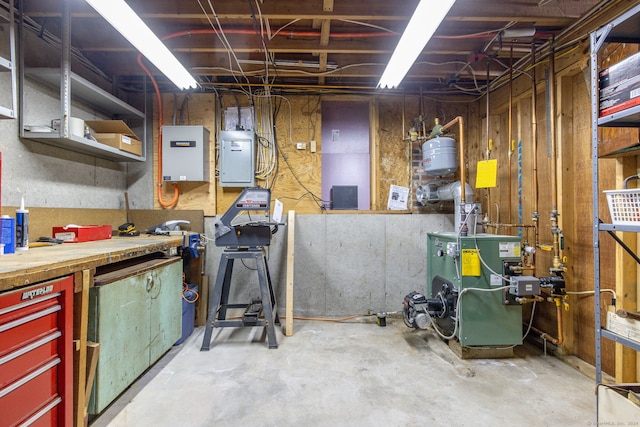 basement with a workshop area and electric panel