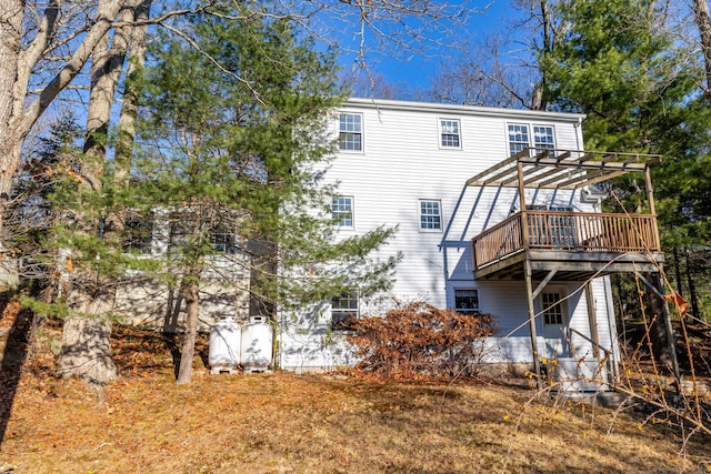 back of house with a pergola and a deck