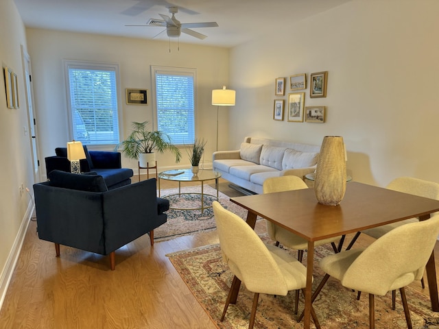 living room with ceiling fan and light hardwood / wood-style floors