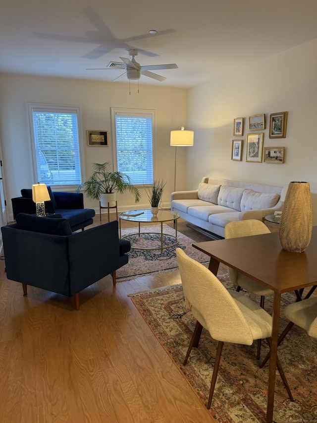 living room featuring light wood-type flooring and ceiling fan