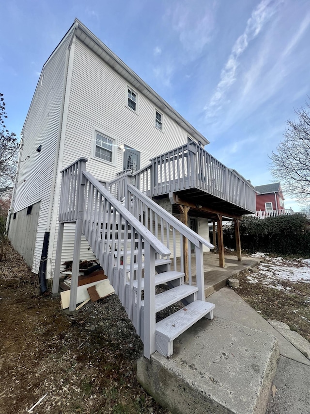 rear view of property featuring a deck