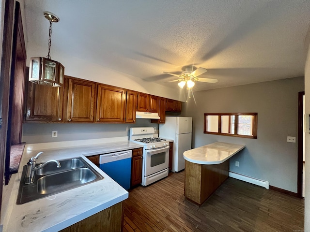 kitchen featuring sink, baseboard heating, dark hardwood / wood-style floors, decorative light fixtures, and white appliances