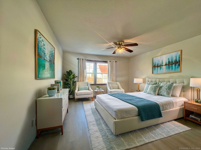 bedroom featuring hardwood / wood-style floors, a textured ceiling, and ceiling fan