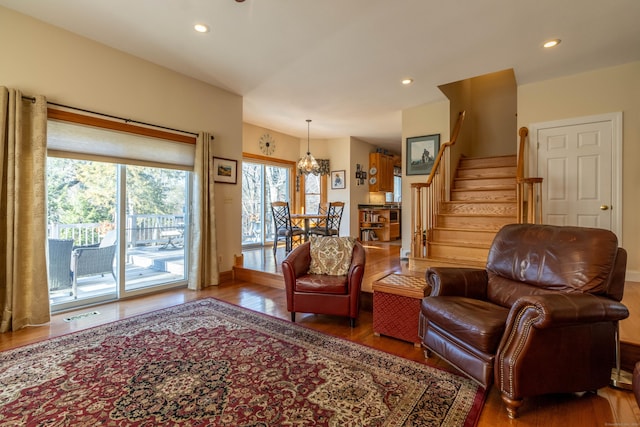 living area featuring an inviting chandelier and hardwood / wood-style flooring