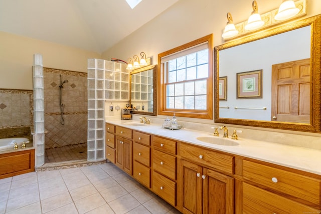 bathroom with vanity, tile patterned flooring, plus walk in shower, and vaulted ceiling with skylight