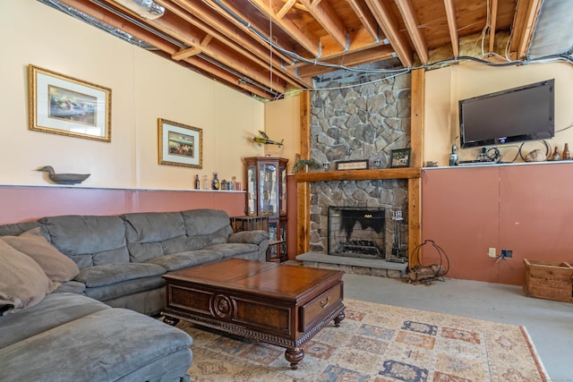 living room with a fireplace and concrete floors