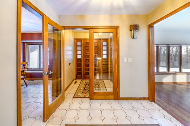 hallway featuring french doors and light wood-type flooring