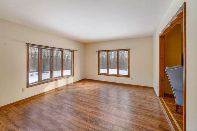 unfurnished living room with wood-type flooring