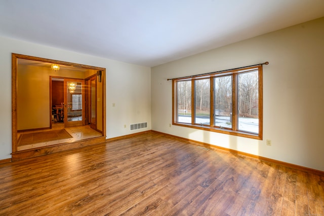 spare room with hardwood / wood-style floors