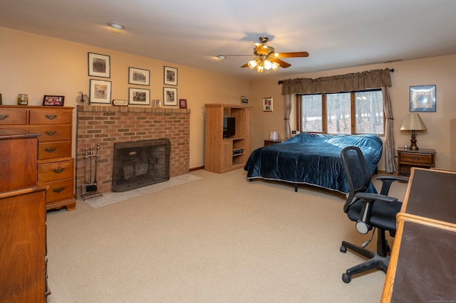 carpeted bedroom with ceiling fan and a brick fireplace