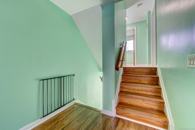 stairway featuring hardwood / wood-style flooring