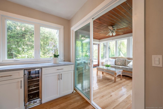 interior space featuring wooden ceiling, beverage cooler, and a healthy amount of sunlight