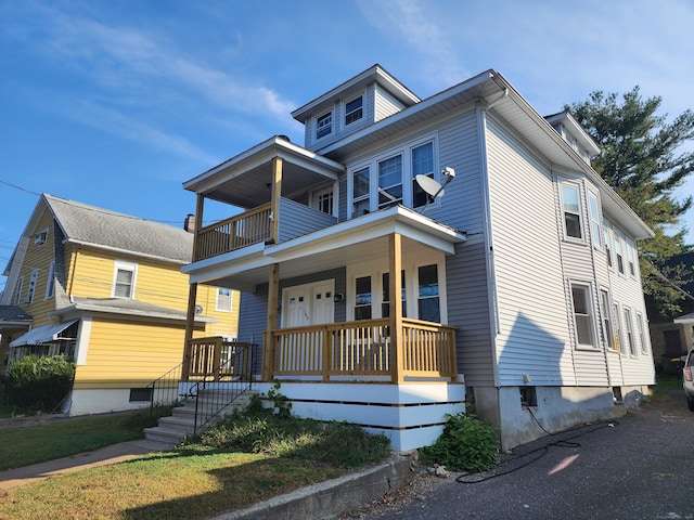 view of front of home featuring covered porch and a balcony