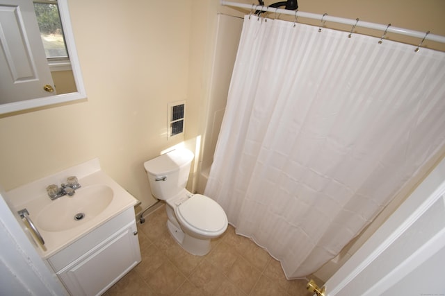 bathroom featuring tile patterned flooring, vanity, and toilet