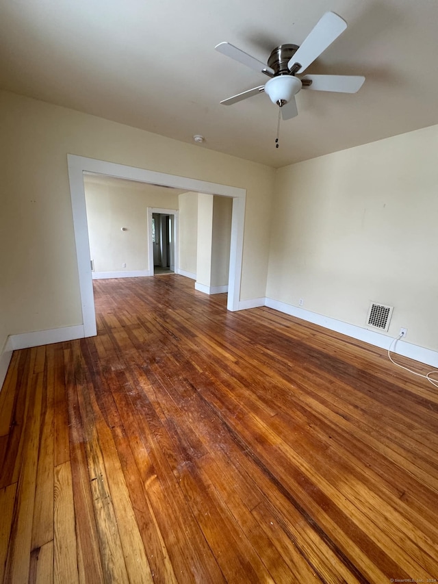 empty room featuring ceiling fan and hardwood / wood-style floors