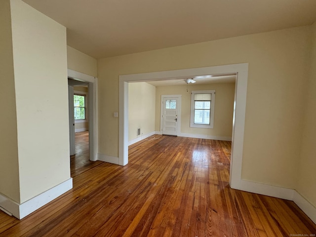 unfurnished room with ceiling fan and hardwood / wood-style flooring