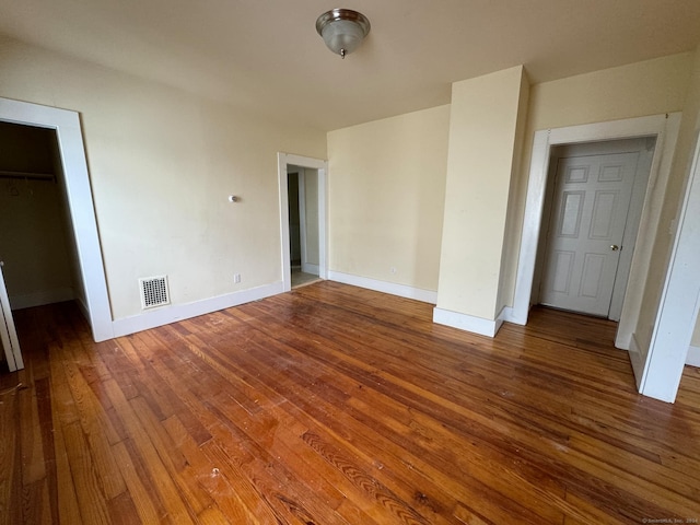 unfurnished bedroom featuring hardwood / wood-style floors and a closet