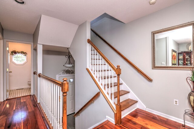 stairway featuring hardwood / wood-style flooring