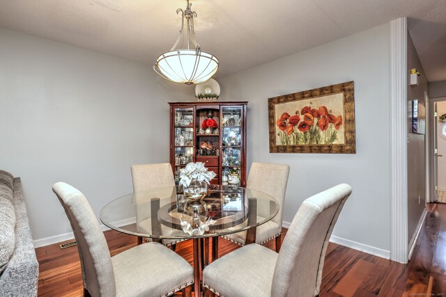 dining area with dark wood-type flooring