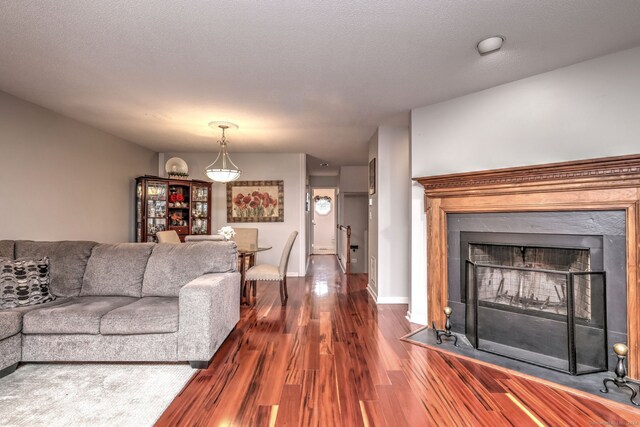 living room featuring dark wood-type flooring and a textured ceiling