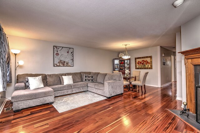 living room featuring hardwood / wood-style floors and a textured ceiling