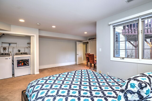 carpeted bedroom with washing machine and clothes dryer