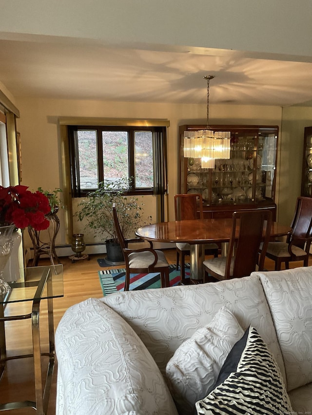 dining room featuring hardwood / wood-style flooring and an inviting chandelier