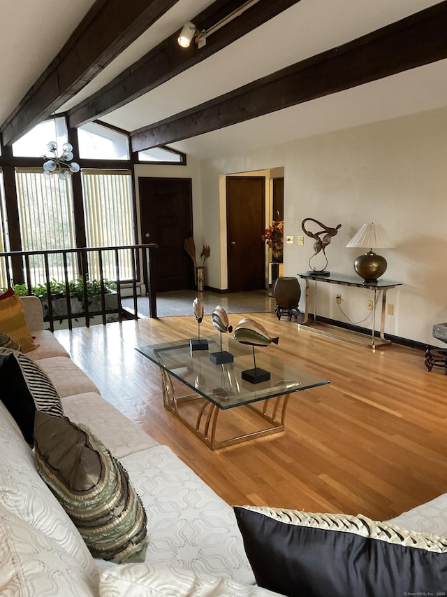 living room featuring expansive windows, beamed ceiling, and wood-type flooring