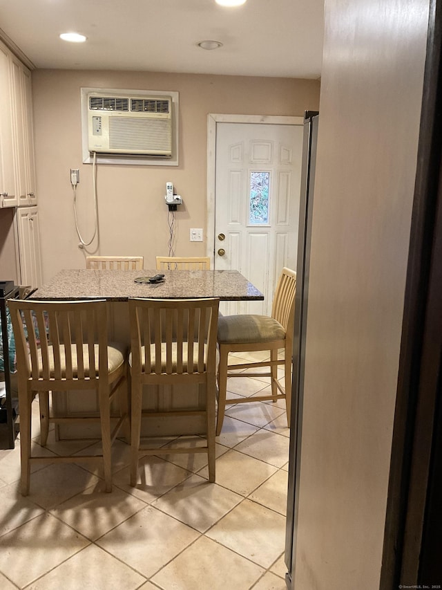 tiled dining area featuring a wall unit AC