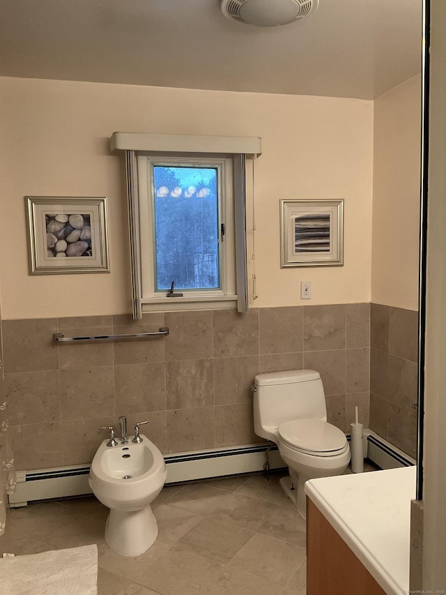 bathroom with tile patterned floors, baseboard heating, a bidet, and tile walls