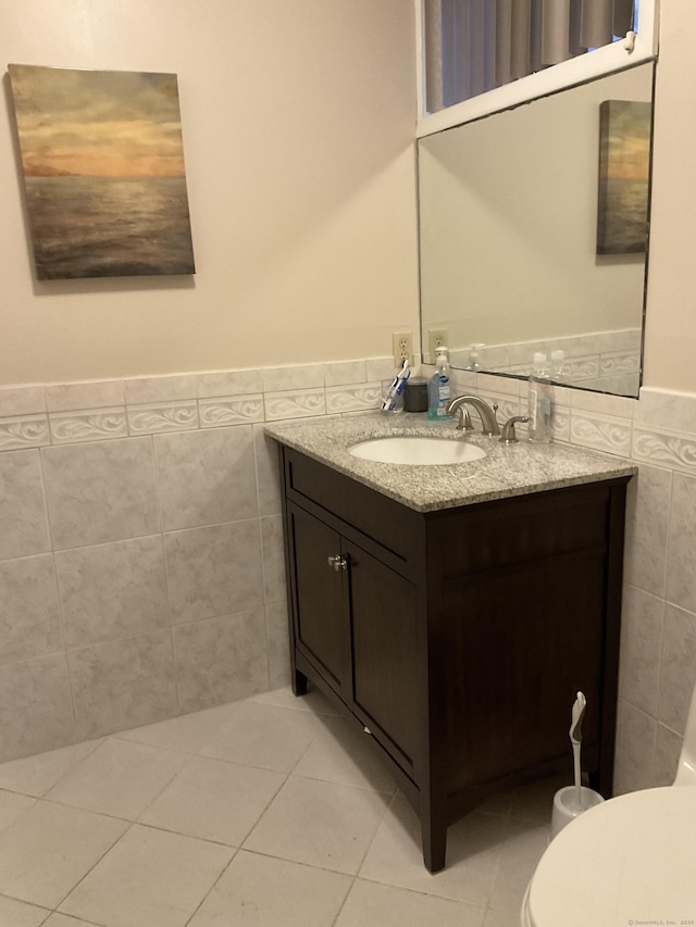 bathroom with vanity, tile patterned floors, and tile walls