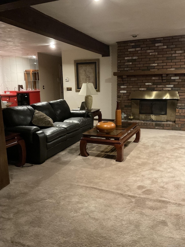 carpeted living room featuring beam ceiling and a fireplace