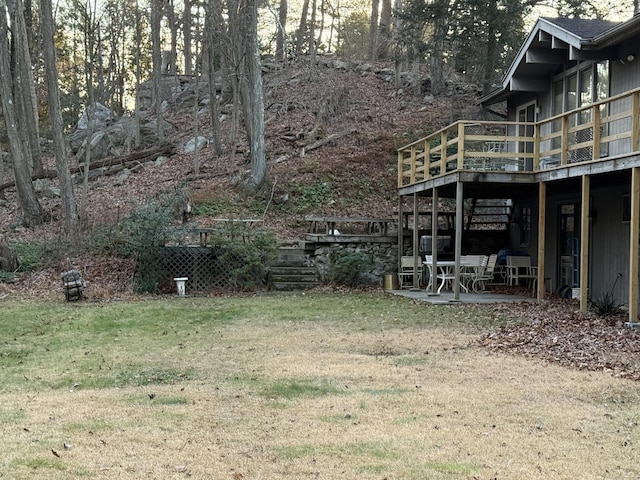 view of yard featuring a patio area and a wooden deck