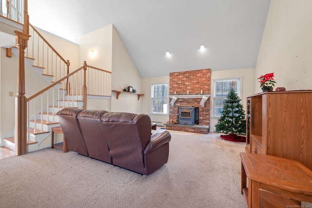 living room with a wood stove, high vaulted ceiling, and light colored carpet