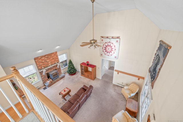 carpeted living room with a fireplace, high vaulted ceiling, and ceiling fan