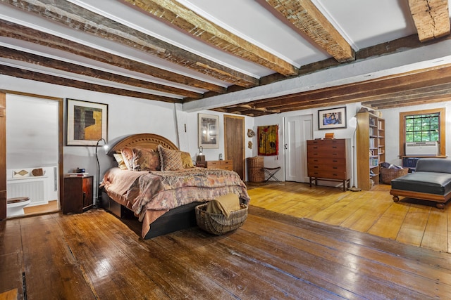 bedroom with hardwood / wood-style flooring, beam ceiling, radiator heating unit, and cooling unit