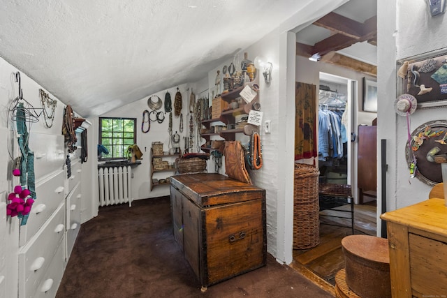 hall with vaulted ceiling with beams, dark carpet, a textured ceiling, and radiator